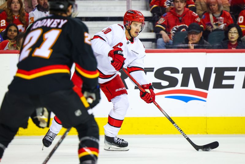 Oct 24, 2024; Calgary, Alberta, CAN; Carolina Hurricanes center Sebastian Aho (20) controls the puck against the Calgary Flames during the first period at Scotiabank Saddledome. Mandatory Credit: Sergei Belski-Imagn Images