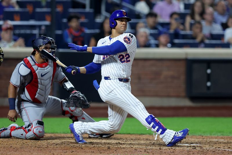 Jun 10, 2025; New York City, New York, USA; New York Mets right fielder Juan Soto (22) follows through on an RBI double against the Washington Nationals during the eighth inning at Citi Field. Mandatory Credit: Brad Penner-Imagn Images