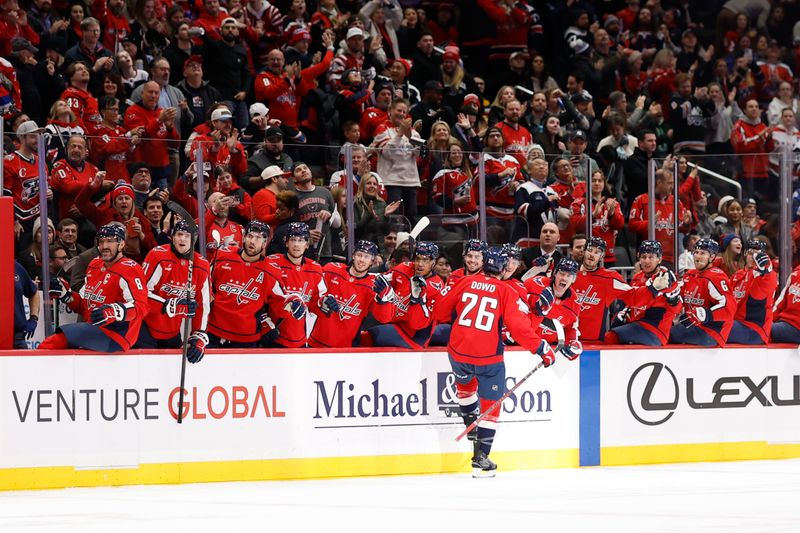 Dec 11, 2025; Washington, District of Columbia, USA; Washington Capitals center Nic Dowd (26) celebrates with teammates after scoring a goal against the Carolina Hurricanes during the third period at Capital One Arena. Mandatory Credit: Geoff Burke-Imagn Images