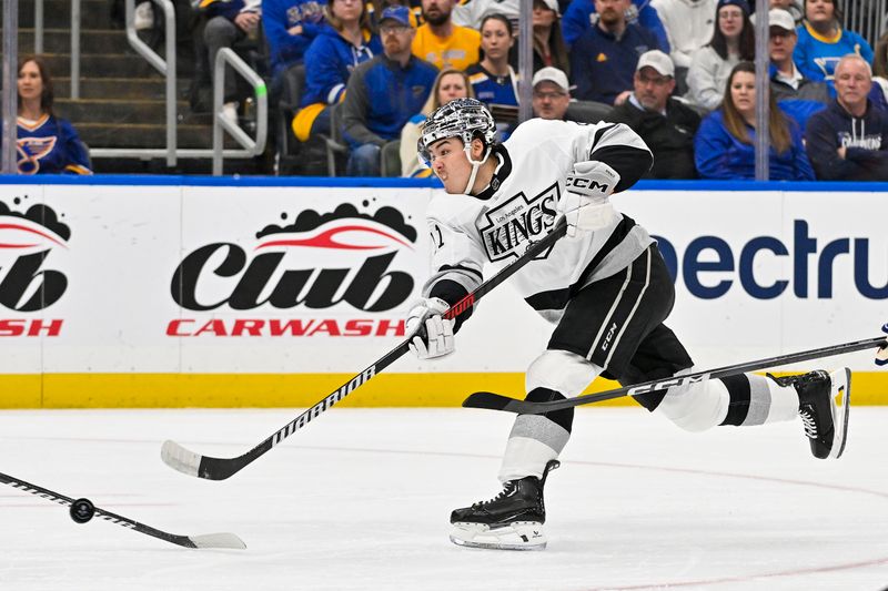 Mar 13, 2024; St. Louis, Missouri, USA;  Los Angeles Kings defenseman Jordan Spence (21) shoots against the St. Louis Blues during the first period at Enterprise Center. Mandatory Credit: Jeff Curry-USA TODAY Sports