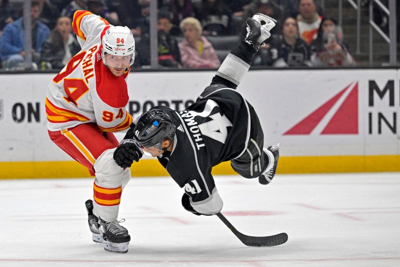 Apr 11, 2024; Los Angeles, California, USA; Los Angeles Kings center Akil Thomas (41) flips on the ice after shooting a goal past Calgary Flames defenseman Brayden Pachal (94) in the second period at Crypto.com Arena. Mandatory Credit: Jayne Kamin-Oncea-USA TODAY Sports