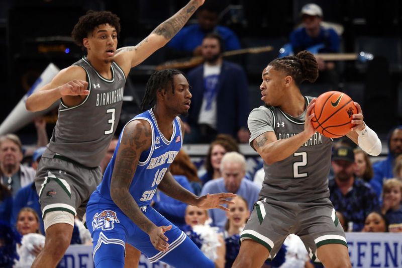 Mar 3, 2024; Memphis, Tennessee, USA; UAB Blazers guard Daniel Ortiz (2) handles the ball as Memphis Tigers guard Jaykwon Walton (10) defends during the first half at FedExForum. Mandatory Credit: Petre Thomas-USA TODAY Sports