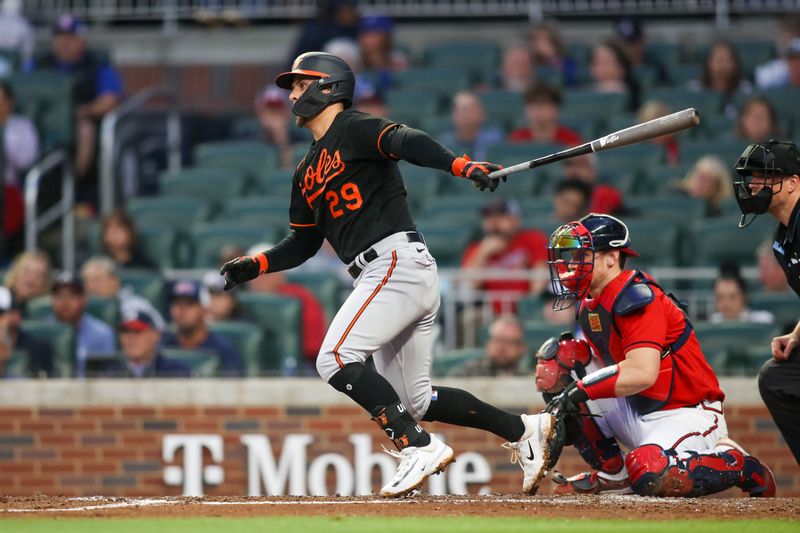 May 5, 2023; Atlanta, Georgia, USA; Baltimore Orioles second baseman Ramon Urias (29) hits a single against the Atlanta Braves in the fourth inning at Truist Park. Mandatory Credit: Brett Davis-USA TODAY Sports