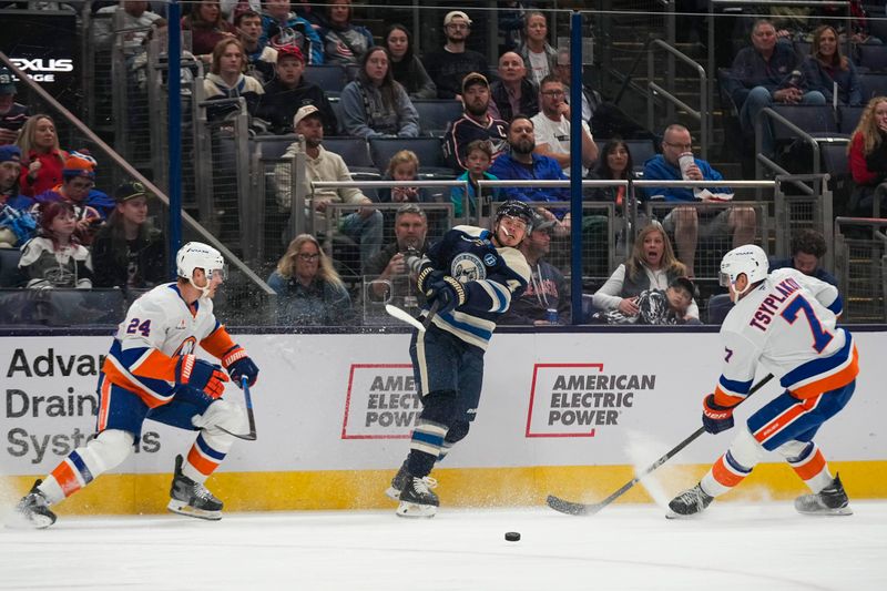 Oct 30, 2024; Columbus, Ohio, USA; Columbus Blue Jackets center Cole Sillinger (4) passes the puck against the New York Islanders in the first period at Nationwide Arena. Mandatory Credit: Samantha Madar-Imagn Images