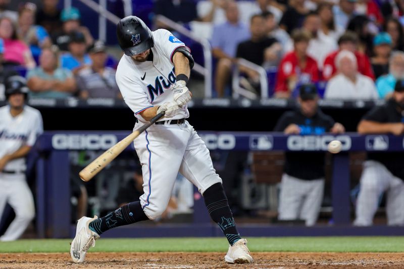 Jul 30, 2023; Miami, Florida, USA; Miami Marlins center fielder Garrett Hampson (1) hits a single against the Detroit Tigers during the seventh inning at loanDepot Park. Mandatory Credit: Sam Navarro-USA TODAY Sports