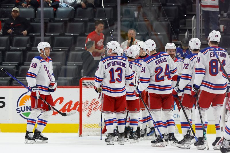 Oct 17, 2024; Detroit, Michigan, USA;  New York Rangers  celebrate after defeating the Detroit Red Wings at Little Caesars Arena. Mandatory Credit: Rick Osentoski-Imagn Images