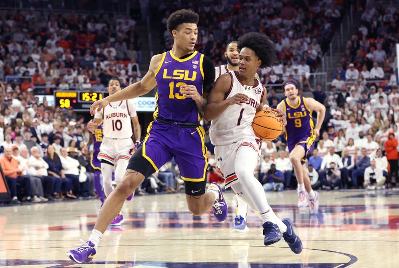 Jan 13, 2024; Auburn, Alabama, USA; LSU Tigers forward Jalen Reed (13) blocks Auburn Tigers guard Aden Holloway (1) during the second half at Neville Arena. Mandatory Credit: John Reed-USA TODAY Sports