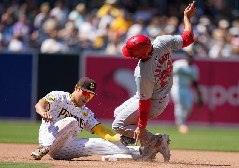 Apr 3, 2024; San Diego, California, USA; San Diego Padres shortstop Ha-Seong Kim (7) tags out St. Louis Cardinals third baseman Nolan Arenado (28) at second base during the fourth inning at Petco Park. Mandatory Credit: Ray Acevedo-USA TODAY Sports