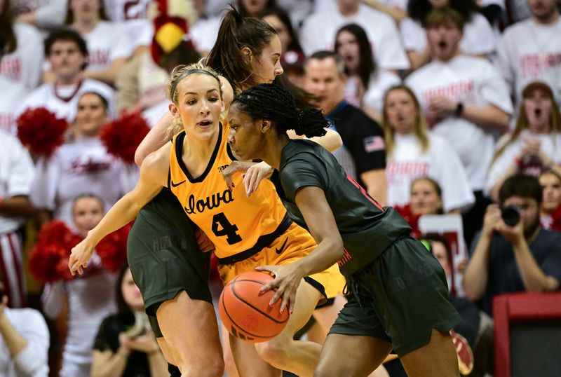 Feb 22, 2024; Bloomington, Indiana, USA; Indiana Hoosiers guard Chloe Moore-McNeil (22) dribbles the ball past Iowa Hawkeyes guard Kylie Feuerbach (4) during the second quarter at Simon Skjodt Assembly Hall. Mandatory Credit: Marc Lebryk-USA TODAY Sports