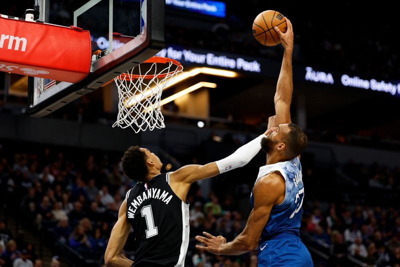 MINNEAPOLIS, MINNESOTA - FEBRUARY 27: Rudy Gobert #27 of the Minnesota Timberwolves dunks the ball over Victor Wembanyama #1 of the San Antonio Spurs in the second quarter at Target Center on February 27, 2024 in Minneapolis, Minnesota. NOTE TO USER: User expressly acknowledges and agrees that, by downloading and or using this photograph, User is consenting to the terms and conditions of the Getty Images License Agreement. (Photo by David Berding/Getty Images)