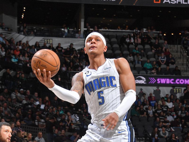 SAN ANTONIO, TX - MARCH 14: Paolo Banchero #5 of the Orlando Magic drives to the basket during the game against the San Antonio Spurs on March 14, 2023 at the AT&T Center in San Antonio, Texas. NOTE TO USER: User expressly acknowledges and agrees that, by downloading and or using this photograph, user is consenting to the terms and conditions of the Getty Images License Agreement. Mandatory Copyright Notice: Copyright 2023 NBAE (Photos by Michael Gonzales/NBAE via Getty Images)