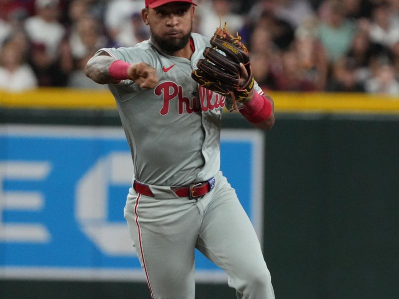 Aug 9, 2024; Phoenix, Arizona, USA; Philadelphia Phillies second base Bryson Stott (5) makes the play for an out against the Arizona Diamondbacks in the first inning at Chase Field. Mandatory Credit: Rick Scuteri-USA TODAY Sports