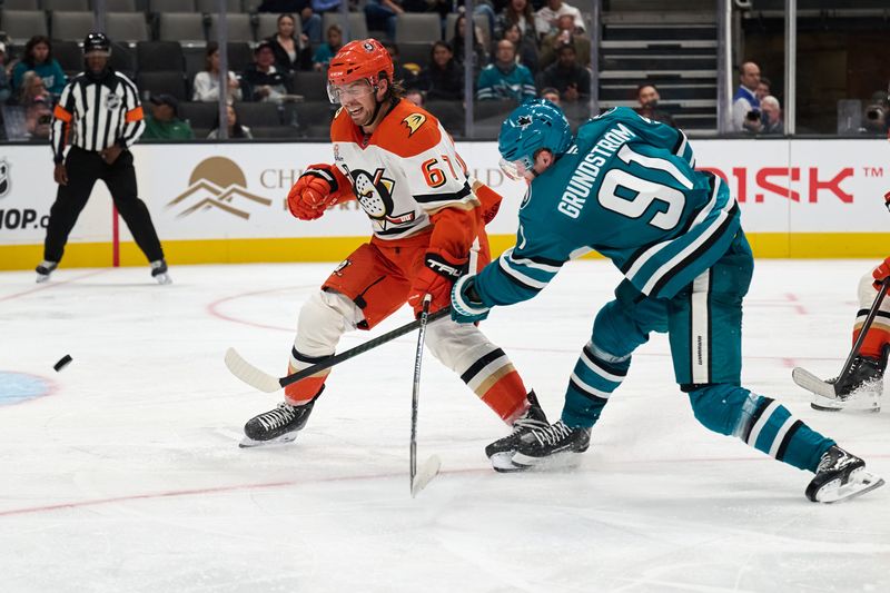 Oct 1, 2025; San Jose, California, USA; San Jose Sharks right wing Carl Grundstrom (91) shoots the puck against Anaheim Ducks defenseman Tristan Luneau (67) during the second period at SAP Center at San Jose. Mandatory Credit: Robert Edwards-Imagn Images