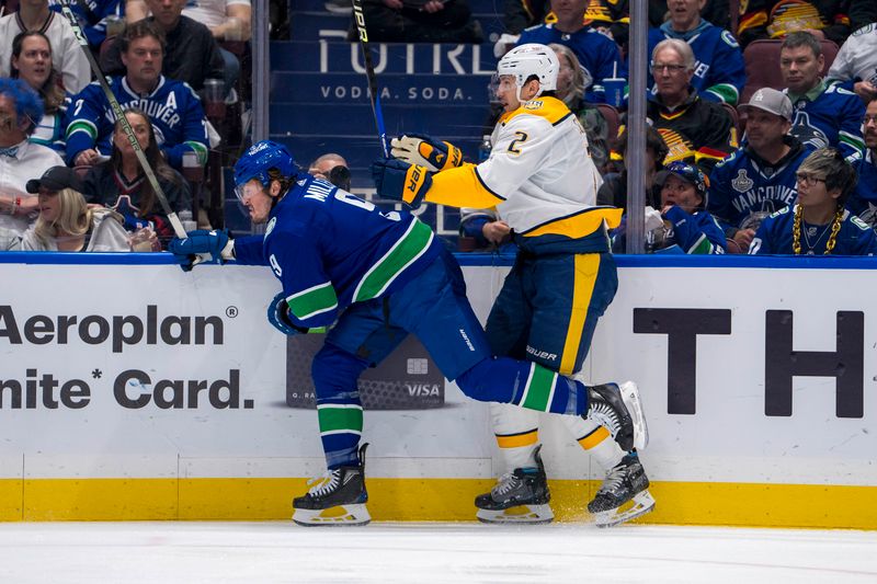 Apr 23, 2024; Vancouver, British Columbia, CAN; Vancouver Canucks forward J.T. Miller (9) checks Nashville Predators defenseman Luke Schenn (2) during the first period in game two of the first round of the 2024 Stanley Cup Playoffs at Rogers Arena. Mandatory Credit: Bob Frid-USA TODAY Sports