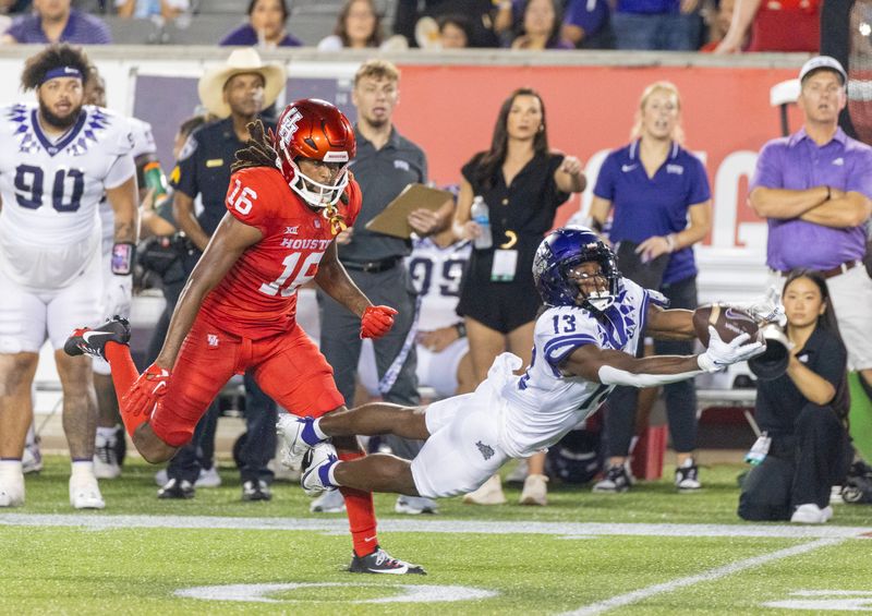 Sep 16, 2023; Houston, Texas, USA;TCU Horned Frogs wide receiver Jaylon Robinson (13) drops a pass while being covered by Houston Cougars defensive back Brian George (16) in the second half at TDECU Stadium. Mandatory Credit: Thomas Shea-USA TODAY Sports