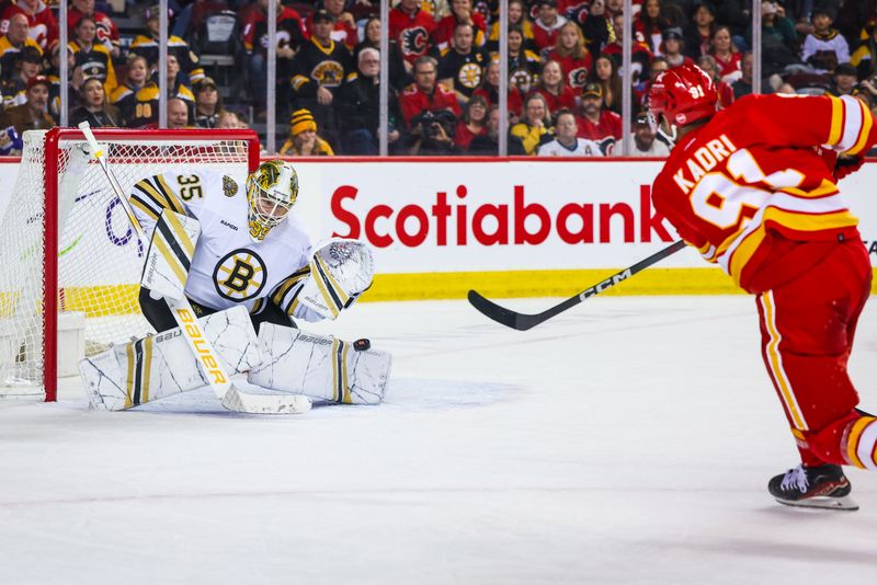 Feb 22, 2024; Calgary, Alberta, CAN; Calgary Flames center Nazem Kadri (91) scores a goal against Boston Bruins goaltender Linus Ullmark (35) during the overtime period at Scotiabank Saddledome. Mandatory Credit: Sergei Belski-USA TODAY Sports