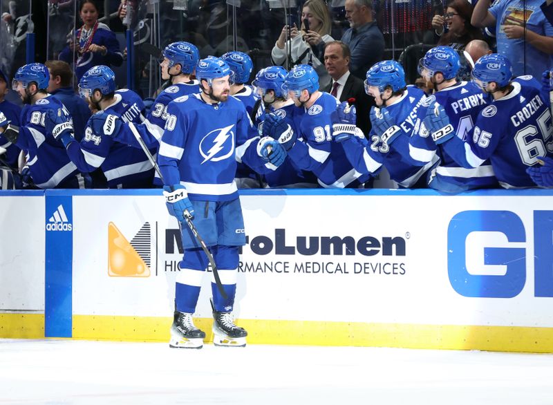 Jan 27, 2024; Tampa, Florida, USA; Tampa Bay Lightning left wing Nicholas Paul (20) is congratulated after he scored a goal against the New Jersey Devils during the second period at Amalie Arena. Mandatory Credit: Kim Klement Neitzel-USA TODAY Sports