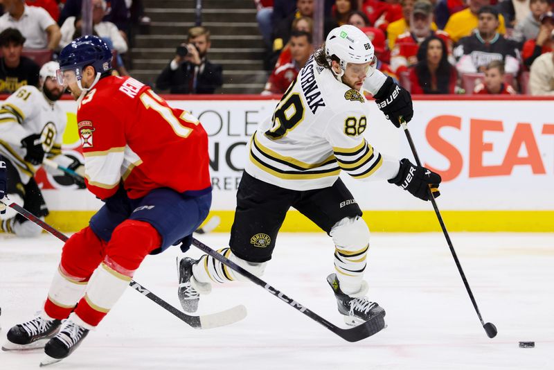 May 14, 2024; Sunrise, Florida, USA; Boston Bruins right wing David Pastrnak (88) moves the puck against Florida Panthers center Sam Reinhart (13) during the third period in game five of the second round of the 2024 Stanley Cup Playoffs at Amerant Bank Arena. Mandatory Credit: Sam Navarro-USA TODAY Sports