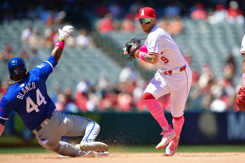 May 12, 2024; Anaheim, California, USA; Kansas City Royals left fielder Dairon Blanco (44) is out at second as Los Angeles Angels shortstop Zach Neto (9) throws to first for the out against right fielder Hunter Renfroe (16) during the sixth inning at Angel Stadium. Mandatory Credit: Gary A. Vasquez-USA TODAY Sports