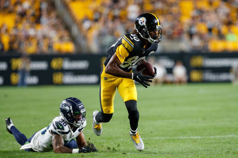 Pittsburgh Steelers wide receiver Tyler Vaughns (80) catches a 24 yard touchdown pass in front of Seattle Seahawks cornerback Josh Valentine-Turner (38) during a preseason NFL football game, Saturday, Aug. 13, 2022, in Pittsburgh, PA. (AP Photo/Matt Durisko)