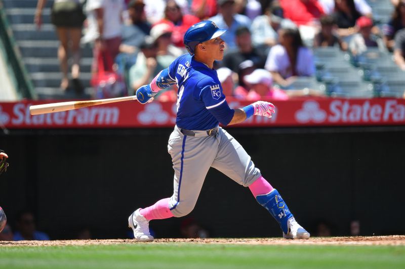 May 12, 2024; Anaheim, California, USA; Kansas City Royals catcher Freddy Fermin (34) hits an RBI single against the Los Angeles Angels during the fourth inning at Angel Stadium. Mandatory Credit: Gary A. Vasquez-USA TODAY Sports