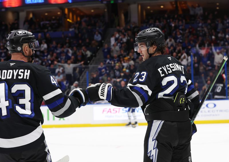 Nov 30, 2024; Tampa, Florida, USA; Tampa Bay Lightning center Michael Eyssimont (23) is congratulated  by defenseman Darren Raddysh (43) after he scored a goal against the Toronto Maple Leafs during the third period at Amalie Arena. Mandatory Credit: Kim Klement Neitzel-Imagn Images