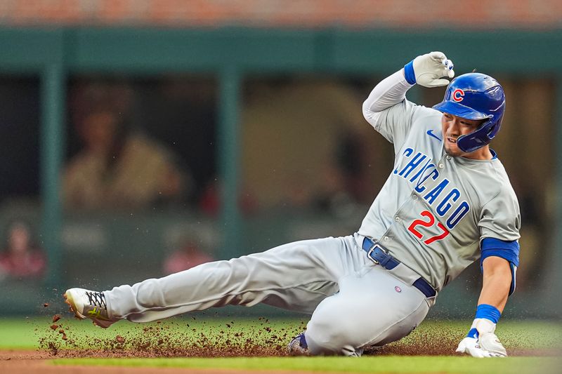 May 15, 2024; Cumberland, Georgia, USA; Chicago Cubs right fielder Seiya Suzuki (27) runs and slides after hitting a double against the Atlanta Braves during the first inning at Truist Park. Mandatory Credit: Dale Zanine-USA TODAY Sports