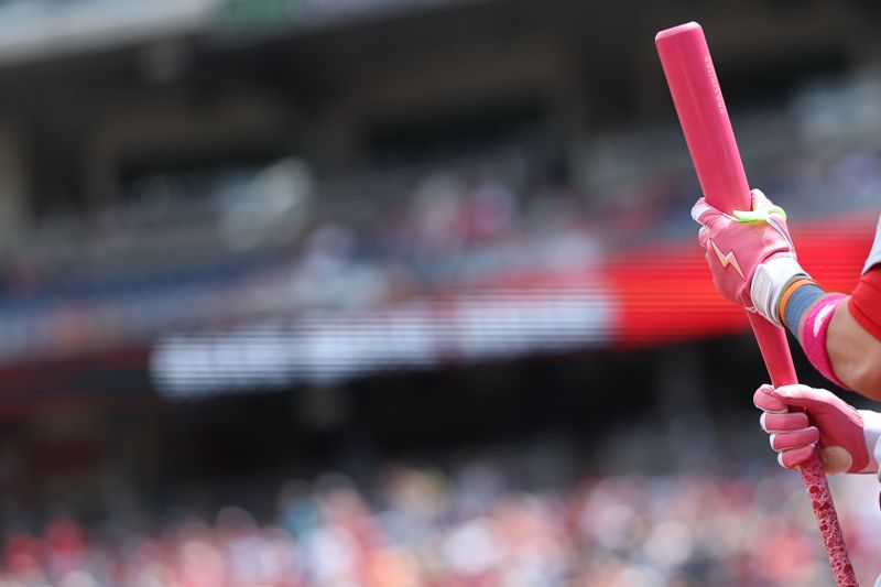 May 11, 2025; Washington, District of Columbia, USA; St. Louis Cardinals outfielder Lars Nootbaar (21) holds his Mother's Day colors bat in the on deck circle prior to an at bat against the Washington Nationals during the first inning at Nationals Park. Mandatory Credit: Geoff Burke-Imagn Images