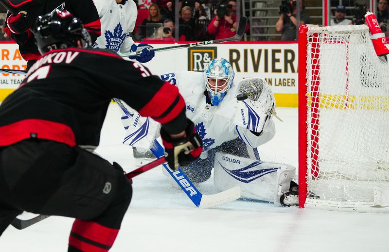 Mar 24, 2024; Raleigh, North Carolina, USA;  Toronto Maple Leafs goaltender Joseph Woll (60) stops the shot by Carolina Hurricanes right wing Andrei Svechnikov (37) during the first period at PNC Arena. Mandatory Credit: James Guillory-USA TODAY Sports