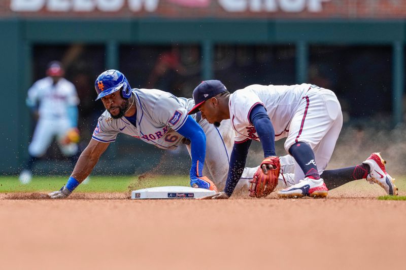 Apr 11, 2024; Cumberland, Georgia, USA; New York Mets right fielder Starling Marte (6) steals second base behind Atlanta Braves second baseman Ozzie Albies (1) during the seventh inning at Truist Park. Mandatory Credit: Dale Zanine-USA TODAY Sports