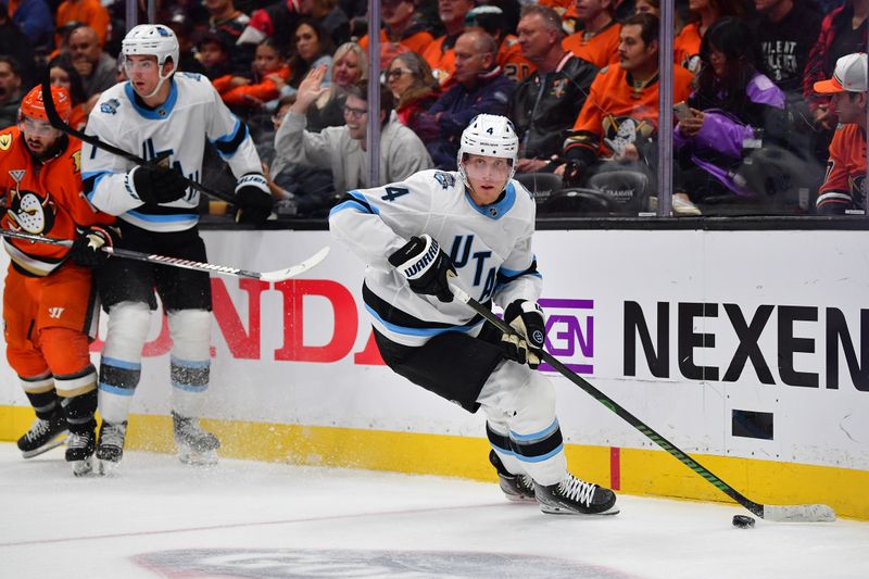 Oct 16, 2024; Anaheim, California, USA; Utah Hockey Club defenseman Juuso Valimaki (4) moves the puck against the Anaheim Ducks during the second period at Honda Center. Mandatory Credit: Gary A. Vasquez-Imagn Images