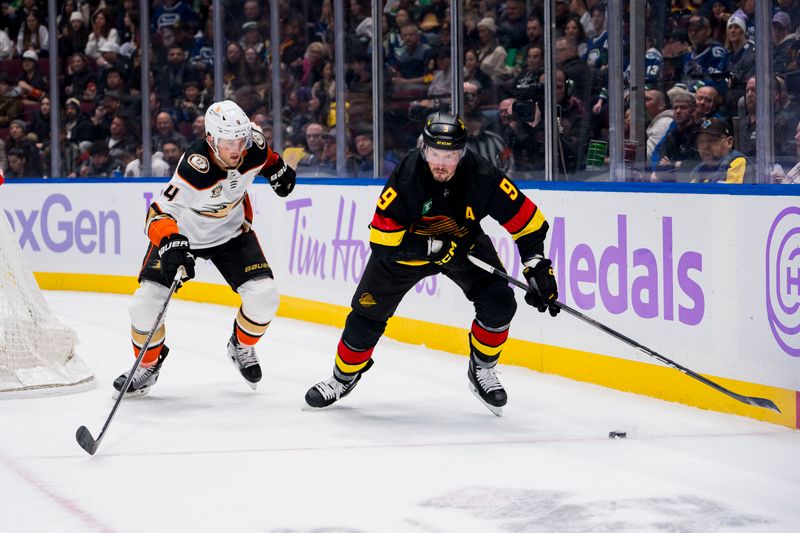 Nov 28, 2023; Vancouver, British Columbia, CAN; Anaheim Ducks defenseman Cam Fowler (4) defends against Vancouver Canucks forward J.T. Miller (9) in the second period at Rogers Arena. Mandatory Credit: Bob Frid-USA TODAY Sports