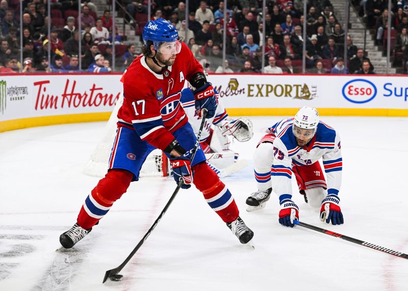 Mar 9, 2023; Montreal, Quebec, CAN; Montreal Canadiens right wing Josh Anderson (17) plays the puck against New York Rangers defenseman K'Andre Miller (79) during the second period at Bell Centre. Mandatory Credit: David Kirouac-USA TODAY Sports