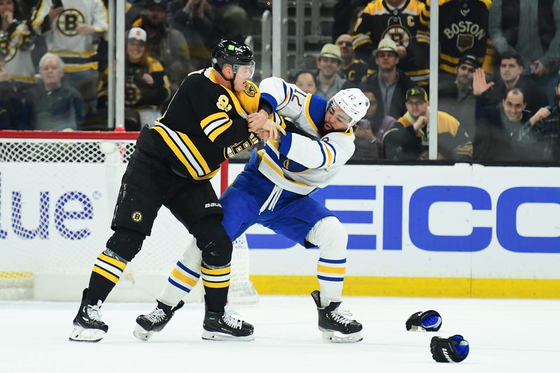Mar 17, 2025; Boston, Massachusetts, USA;  Boston Bruins defenseman Nikita Zadorov (91) fights with Buffalo Sabres left wing Jordan Greenway (12) during the first period at TD Garden. Mandatory Credit: Bob DeChiara-Imagn Images
