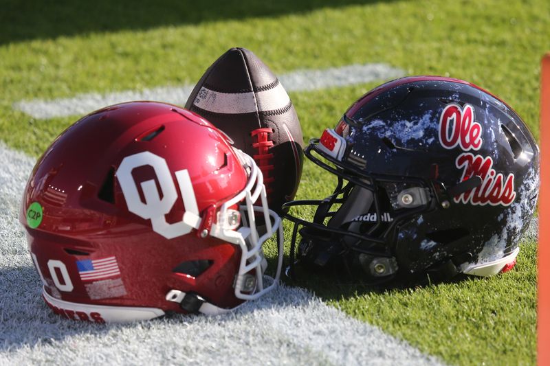 Oct 26, 2024; Oxford, Mississippi, USA; Oklahoma Sooners and Mississippi Rebels helmets sit on the field prior to the game at Vaught-Hemingway Stadium. Mandatory Credit: Petre Thomas-Imagn Images