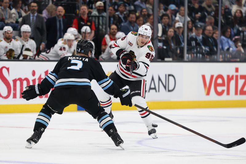 Mar 1, 2026; Salt Lake City, Utah, USA; Chicago Blackhawks right wing Ilya Mikheyev (95) advances the puck against Utah Mammoth defenseman Olli Maatta (2) during the first period at Delta Center. Mandatory Credit: Rob Gray-Imagn Images