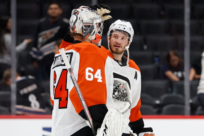 Sep 22, 2024; Washington, District of Columbia, USA; Philadelphia Flyers goaltender Carson Bjarnason (64) celebrates with Flyers forward Joel Farabee (86) after their game against the Washington Capitals at Capital One Arena. Mandatory Credit: Geoff Burke-Imagn Images