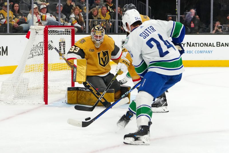 Mar 7, 2024; Las Vegas, Nevada, USA; Vegas Golden Knights goaltender Adin Hill (33) defends his net against Vancouver Canucks center Pius Suter (24) during the first period at T-Mobile Arena. Mandatory Credit: Stephen R. Sylvanie-USA TODAY Sports