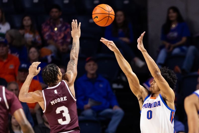 Jan 24, 2024; Gainesville, Florida, USA; Florida Gators guard Zyon Pullin (0) shoots over Mississippi State Bulldogs guard Shakeel Moore (3) during the first half at Exactech Arena at the Stephen C. O'Connell Center. Mandatory Credit: Matt Pendleton-USA TODAY Sports