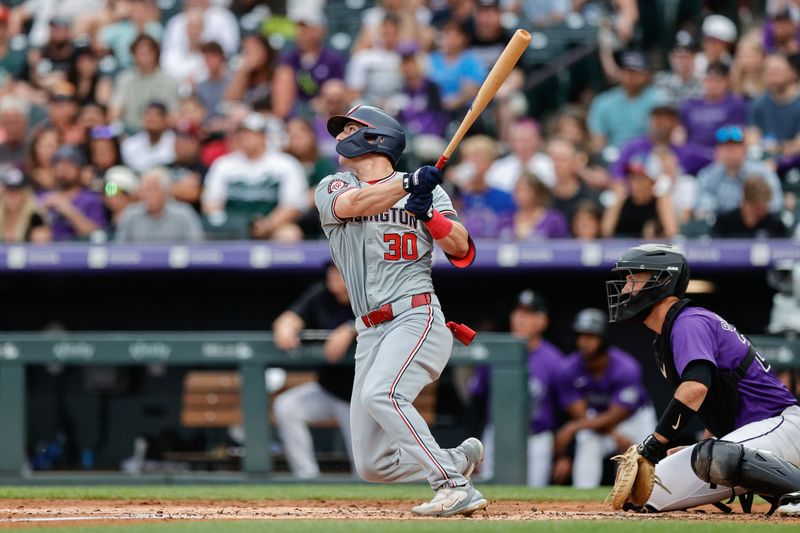 Jun 21, 2024; Denver, Colorado, USA; Washington Nationals center fielder Jacob Young (30) hits a double in the third inning against the Colorado Rockies at Coors Field. Mandatory Credit: Isaiah J. Downing-USA TODAY Sports