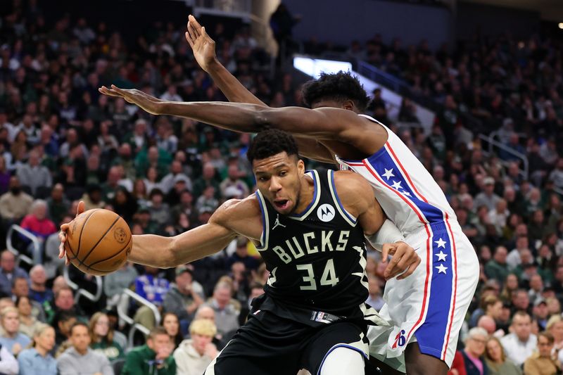 MILWAUKEE, WISCONSIN - MARCH 14: Giannis Antetokounmpo #34 of the Milwaukee Bucks is defended by Mo Bamba #5 of the Philadelphia 76ers during the first half of a game at Fiserv Forum on March 14, 2024 in Milwaukee, Wisconsin. NOTE TO USER: User expressly acknowledges and agrees that, by downloading and or using this photograph, User is consenting to the terms and conditions of the Getty Images License Agreement. (Photo by Stacy Revere/Getty Images)