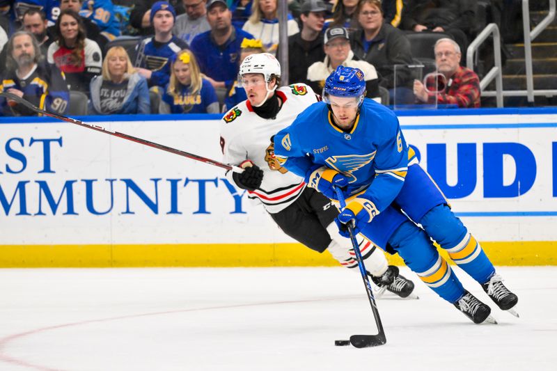 Mar 22, 2025; St. Louis, Missouri, USA;  St. Louis Blues defenseman Philip Broberg (6) controls the puck against the Chicago Blackhawks during the first period at Enterprise Center. Mandatory Credit: Jeff Curry-Imagn Images