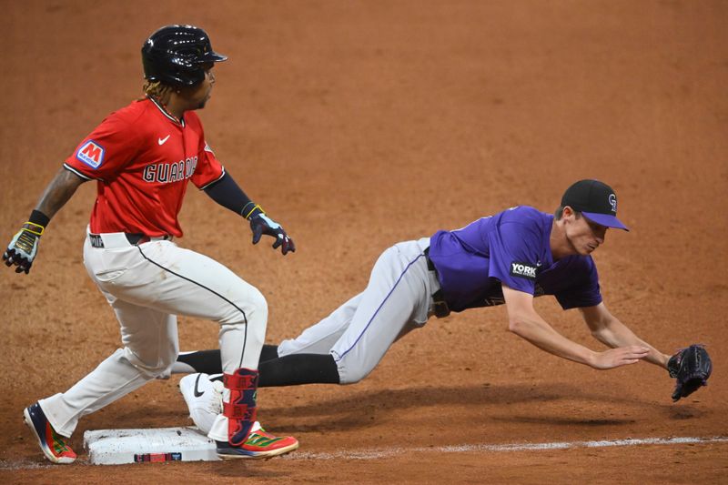 Jul 29, 2025; Cleveland, Ohio, USA; Cleveland Guardians third baseman Jose Ramirez (11) grounds out as Colorado Rockies relief pitcher Jimmy Herget (44) covers first base in the seventh inning at Progressive Field. Mandatory Credit: David Richard-Imagn Images