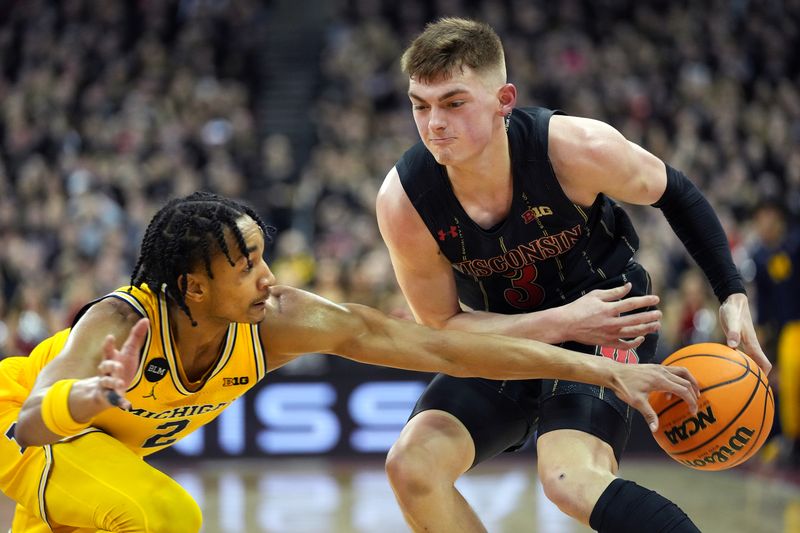 Feb 14, 2023; Madison, Wisconsin, USA; Michigan Wolverines guard Kobe Bufkin (2) knocks the ball loose from Wisconsin Badgers guard Connor Essegian (3) during the second half at the Kohl Center. Mandatory Credit: Kayla Wolf-USA TODAY Sports