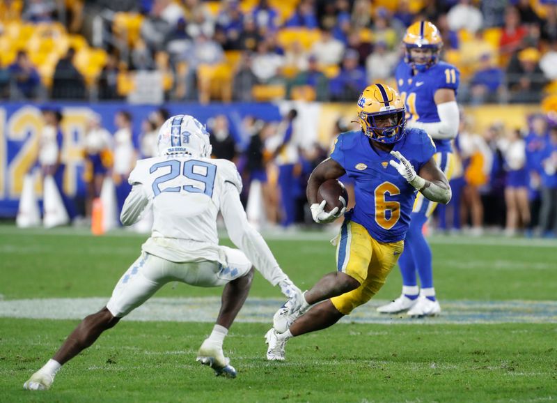 Sep 23, 2023; Pittsburgh, Pennsylvania, USA; Pittsburgh Panthers running back Rodney Hammond Jr. (6) carries the ball against North Carolina Tar Heels defensive back Marcus Allen (29) during the third quarter at Acrisure Stadium. The Tar Heels won 41-24. Mandatory Credit: Charles LeClaire-USA TODAY Sports