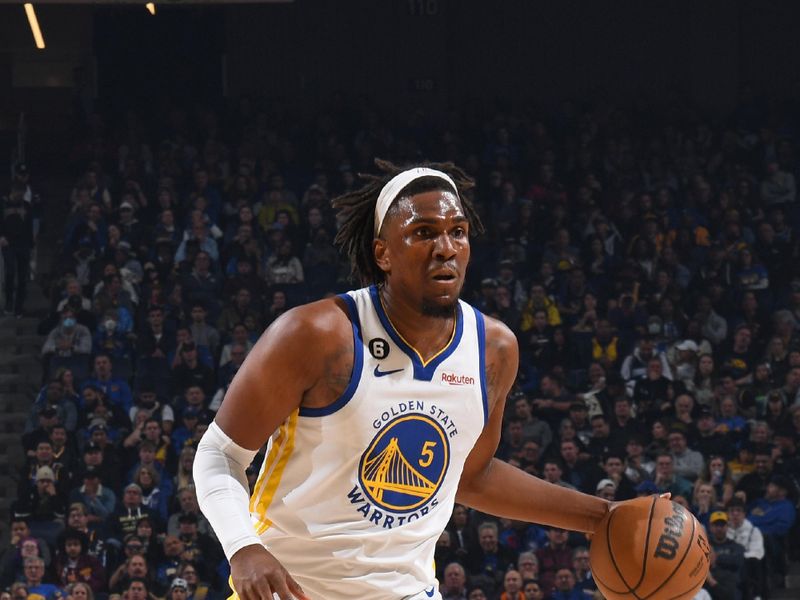 SAN FRANCISCO, CA - MARCH 24: Kevon Looney #5 of the Golden State Warriors handles the ball during the game against the Philadelphia 76ers on March 24, 2023 at Chase Center in San Francisco, California. NOTE TO USER: User expressly acknowledges and agrees that, by downloading and or using this photograph, user is consenting to the terms and conditions of Getty Images License Agreement. Mandatory Copyright Notice: Copyright 2023 NBAE (Photo by Noah Graham/NBAE via Getty Images)