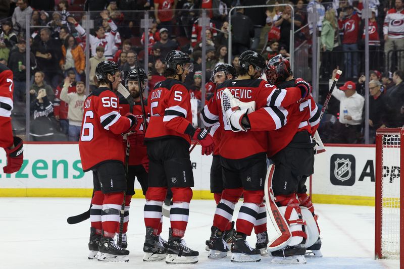 Nov 21, 2024; Newark, New Jersey, USA; The New Jersey Devils celebrate their win over the Carolina Hurricanes at Prudential Center. Mandatory Credit: Ed Mulholland-Imagn Images