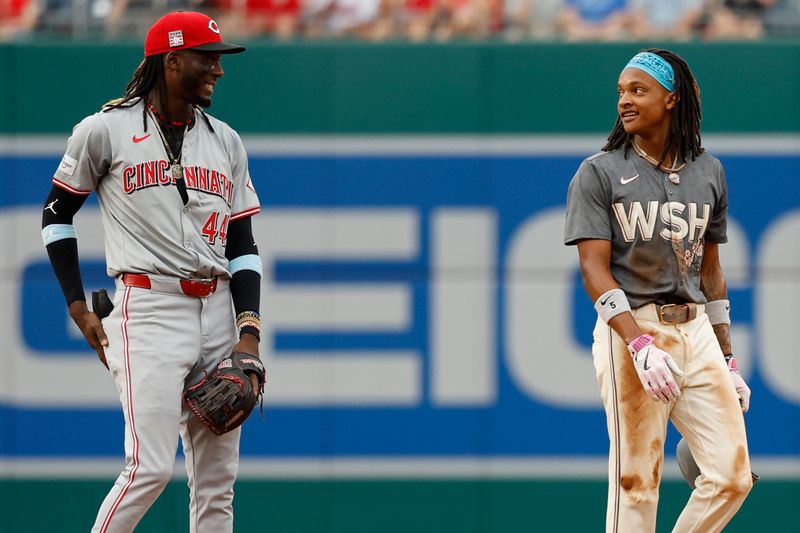 Jul 20, 2024; Washington, District of Columbia, USA; Washington Nationals shortstop CJ Abrams (5) jokes with Cincinnati Reds shortstop Elly De La Cruz (44) after stealing second base during the first inning at Nationals Park. Mandatory Credit: Geoff Burke-USA TODAY Sports