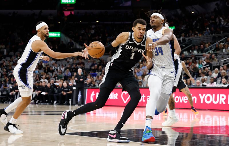 SAN ANTONIO, TX - JANUARY  31:  Victor Wembanyama #1 of the San Antonio Spurs drives on Wendell Carter Jr. #34 of the Orlando Magic in the second half at Frost Bank Center on January 31, 2024 in San Antonio, Texas. NOTE TO USER: User expressly acknowledges and agrees that, by downloading and or using this photograph, User is consenting to terms and conditions of the Getty Images License Agreement. (Photo by Ronald Cortes/Getty Images)