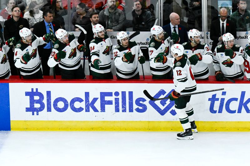 Nov 10, 2024; Chicago, Illinois, USA;  Minnesota Wild left wing Matt Boldy (12) celebrates with teammates  after scoring a goal against the Chicago Blackhawks during the third  period at the United Center. Mandatory Credit: Matt Marton-Imagn Images